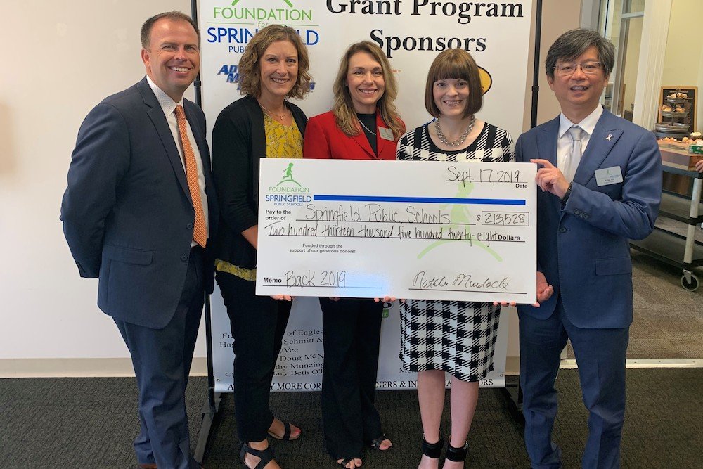 SPS Superintendent John Jungmann, from left, Board of Education member Jill Patterson, and Foundation for Springfield Public Schools representatives Natalie Murdock and Peter Lai pose with a $213,528 check on grant day.